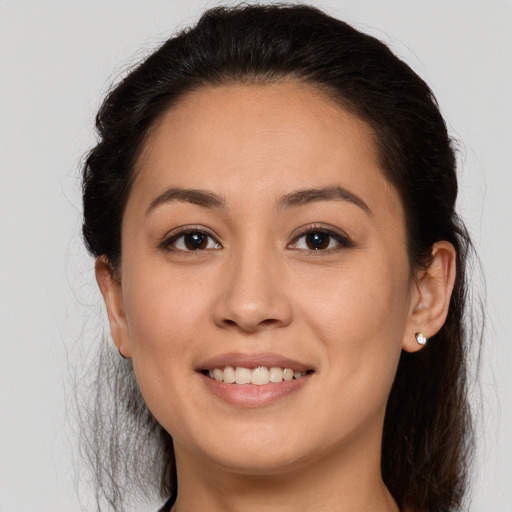 Joyful white young-adult female with long  brown hair and brown eyes