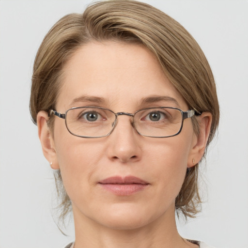 Joyful white adult female with medium  brown hair and grey eyes