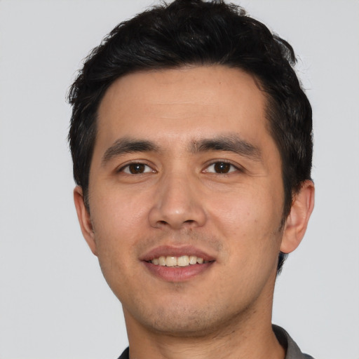 Joyful asian young-adult male with short  black hair and brown eyes
