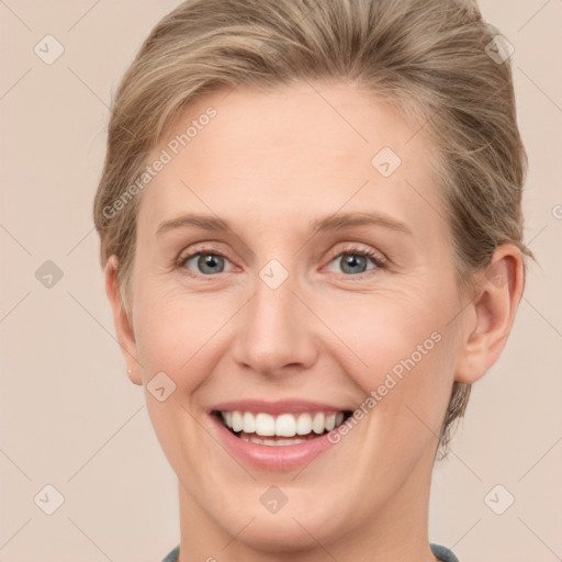 Joyful white young-adult female with short  brown hair and grey eyes