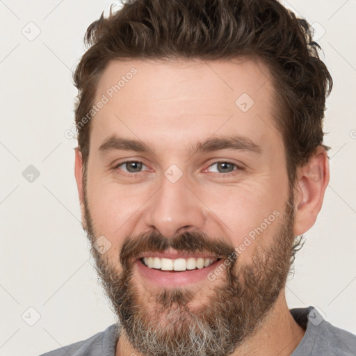 Joyful white adult male with short  brown hair and brown eyes