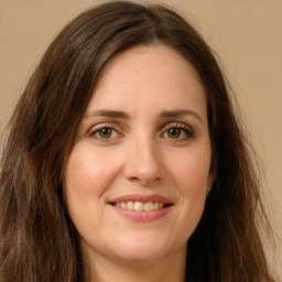 Joyful white young-adult female with long  brown hair and green eyes