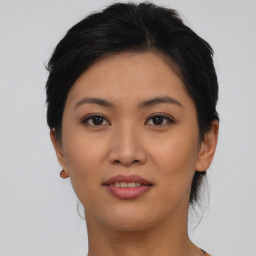 Joyful asian young-adult female with short  black hair and brown eyes