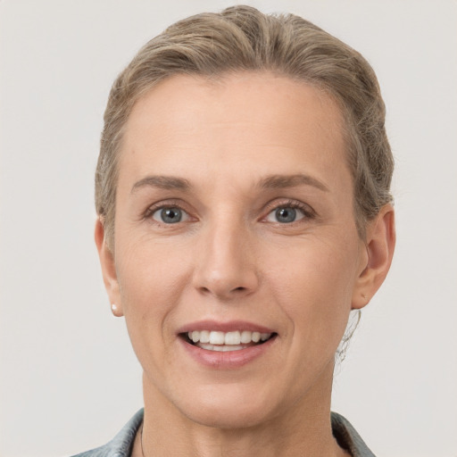 Joyful white adult female with short  brown hair and grey eyes