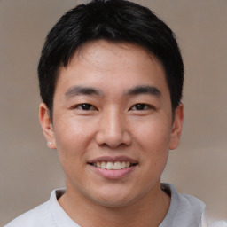 Joyful asian young-adult male with short  black hair and brown eyes