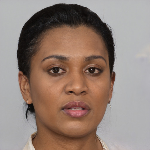 Joyful black young-adult female with short  brown hair and brown eyes