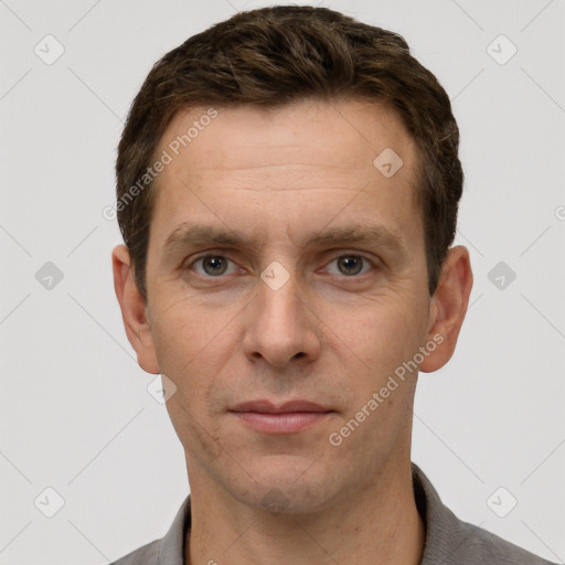 Joyful white adult male with short  brown hair and grey eyes