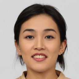 Joyful asian young-adult female with medium  brown hair and brown eyes