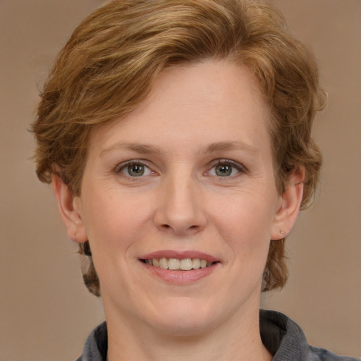 Joyful white adult female with medium  brown hair and blue eyes