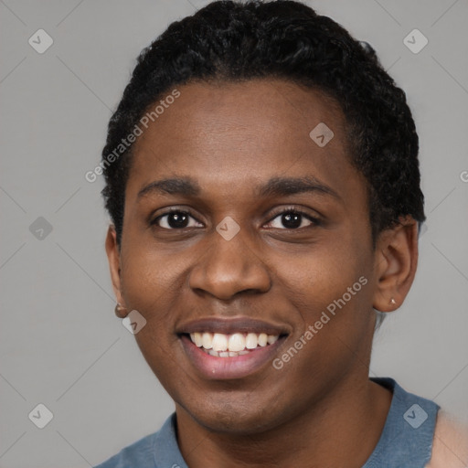 Joyful black young-adult male with short  black hair and brown eyes