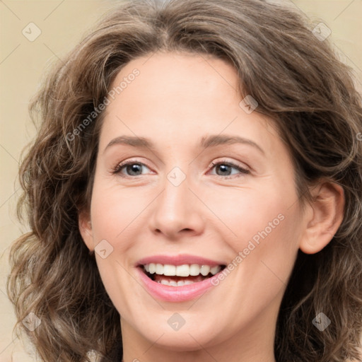 Joyful white young-adult female with medium  brown hair and green eyes