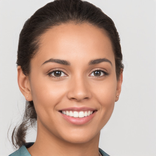 Joyful white young-adult female with long  brown hair and brown eyes