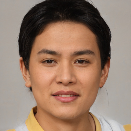 Joyful asian young-adult male with short  brown hair and brown eyes