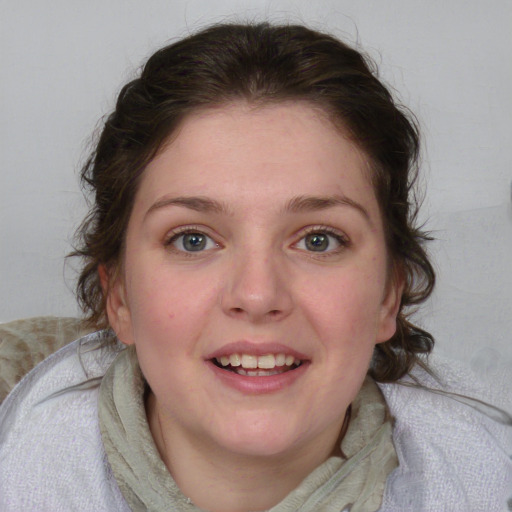 Joyful white young-adult female with medium  brown hair and blue eyes