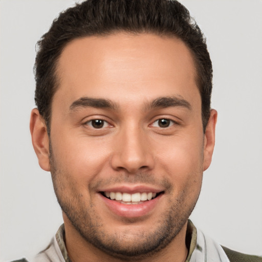 Joyful white young-adult male with short  brown hair and brown eyes