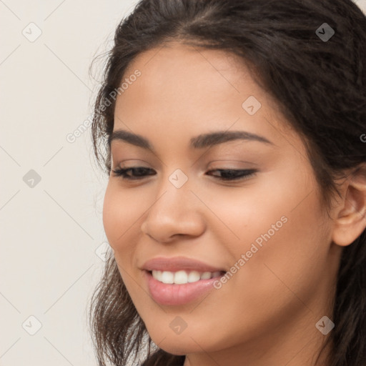 Joyful latino young-adult female with long  brown hair and brown eyes