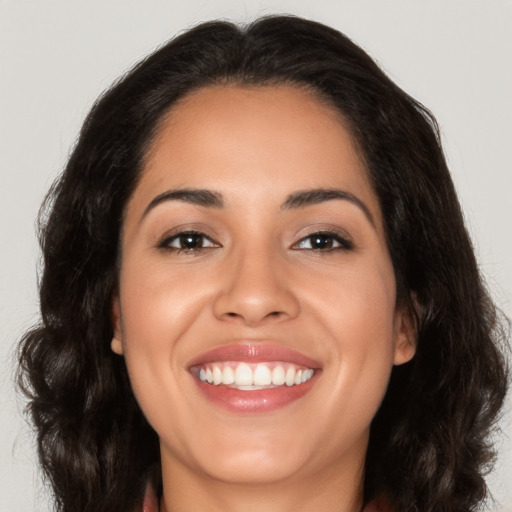 Joyful latino young-adult female with medium  brown hair and brown eyes