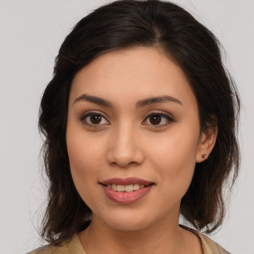 Joyful white young-adult female with medium  brown hair and brown eyes