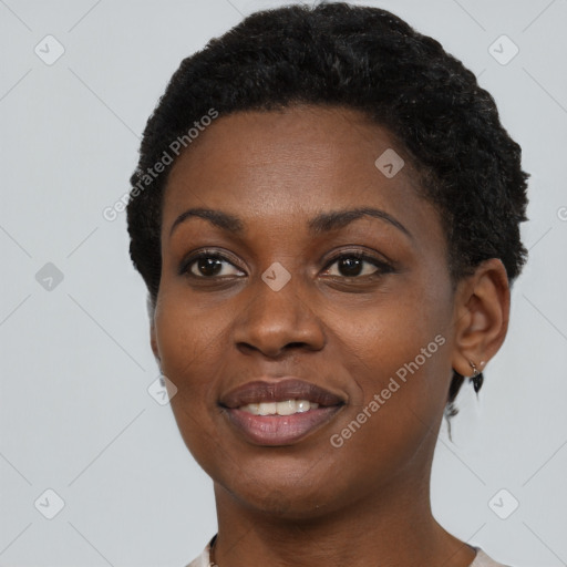 Joyful black young-adult female with short  black hair and brown eyes