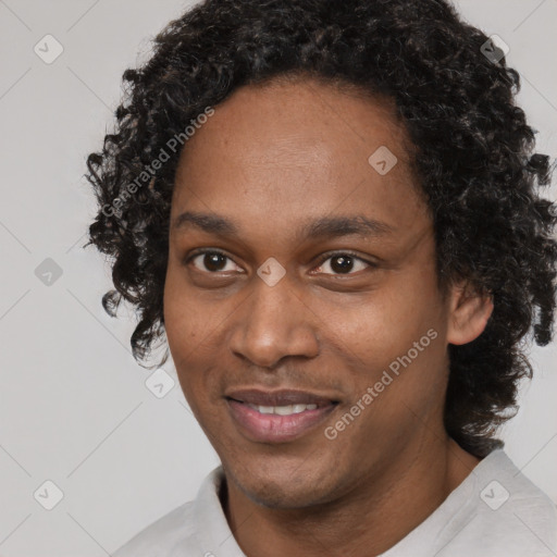 Joyful black young-adult male with short  black hair and brown eyes