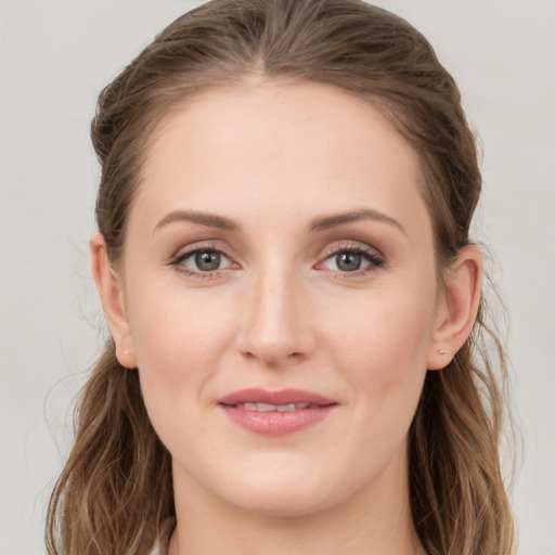 Joyful white young-adult female with long  brown hair and grey eyes