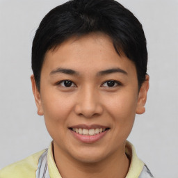 Joyful asian young-adult female with short  black hair and brown eyes