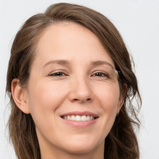 Joyful white young-adult female with long  brown hair and grey eyes