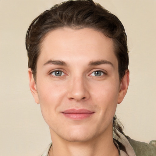 Joyful white young-adult female with short  brown hair and grey eyes