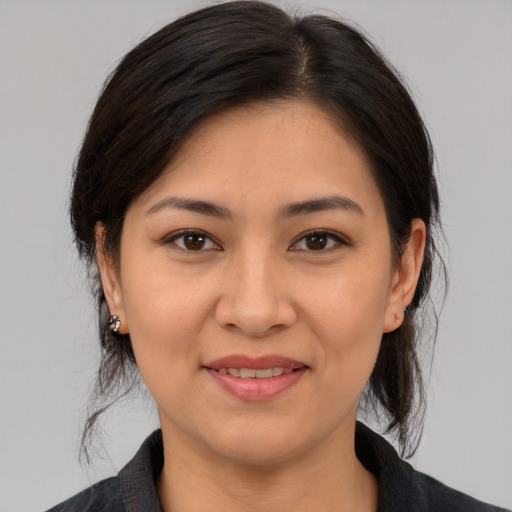 Joyful asian young-adult female with medium  brown hair and brown eyes
