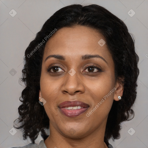 Joyful black adult female with medium  brown hair and brown eyes