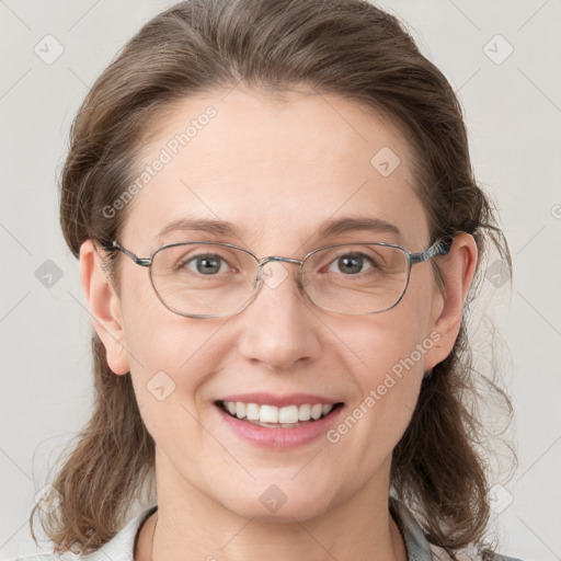 Joyful white adult female with medium  brown hair and grey eyes