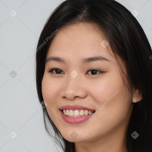 Joyful asian young-adult female with long  brown hair and brown eyes