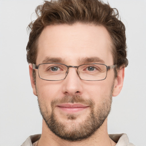 Joyful white adult male with short  brown hair and grey eyes