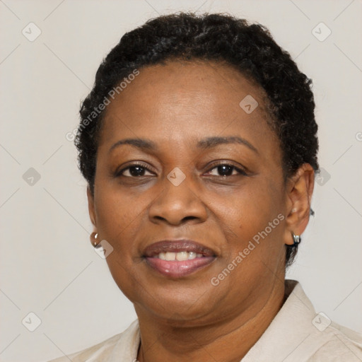 Joyful black adult female with short  brown hair and brown eyes