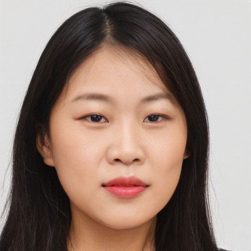 Joyful asian young-adult female with long  brown hair and brown eyes