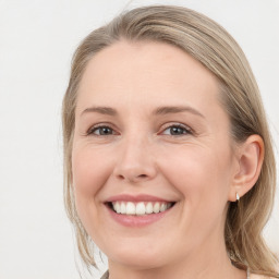 Joyful white young-adult female with long  brown hair and grey eyes