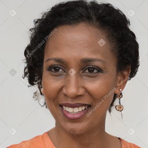 Joyful black adult female with short  brown hair and brown eyes