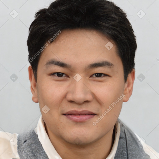 Joyful asian young-adult male with short  black hair and brown eyes