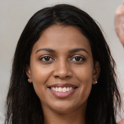 Joyful latino young-adult female with long  brown hair and brown eyes