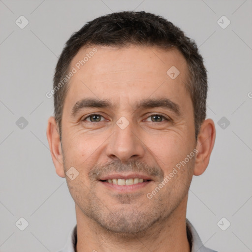 Joyful white adult male with short  brown hair and brown eyes