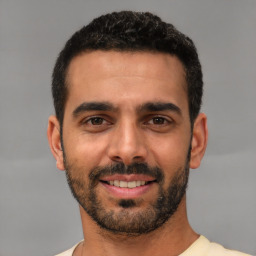 Joyful white young-adult male with short  black hair and brown eyes