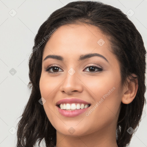 Joyful latino young-adult female with long  brown hair and brown eyes