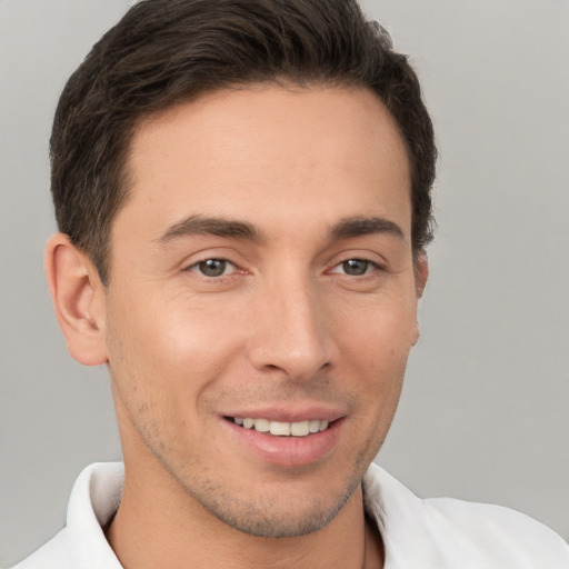 Joyful white young-adult male with short  brown hair and brown eyes