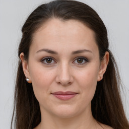 Joyful white young-adult female with long  brown hair and grey eyes