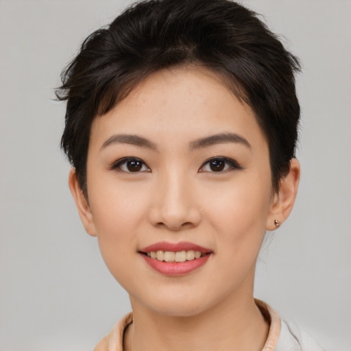 Joyful asian young-adult female with short  black hair and brown eyes