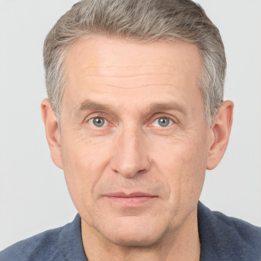 Joyful white middle-aged male with short  brown hair and grey eyes