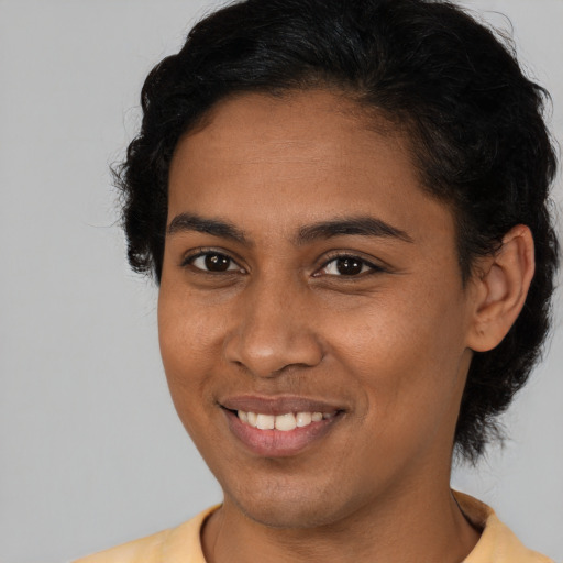 Joyful latino young-adult female with short  brown hair and brown eyes