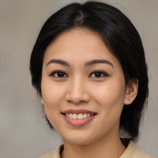 Joyful latino young-adult female with medium  brown hair and brown eyes