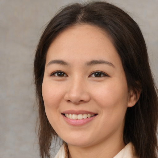 Joyful white young-adult female with medium  brown hair and brown eyes