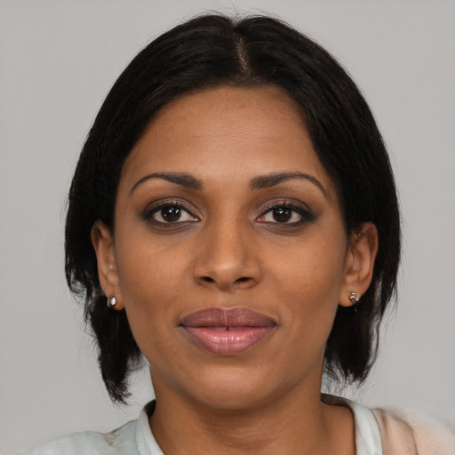 Joyful black young-adult female with medium  black hair and brown eyes